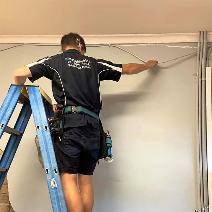 Electrician removing old cable